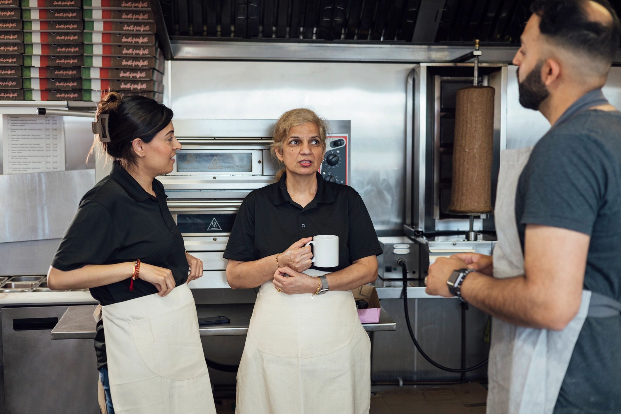 Team members together inside a family-run food shop